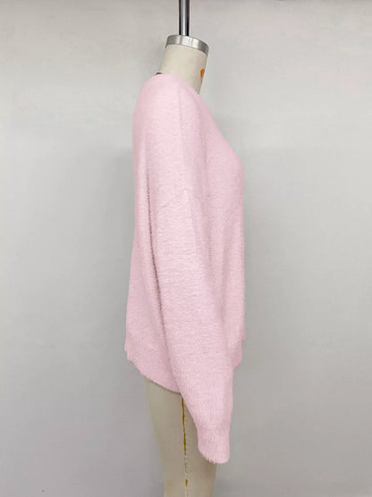 Pink fluffy long sleeve sweater from Trendsi, soft knit fabric with a cozy, relaxed fit and ribbed cuffs and hem.
