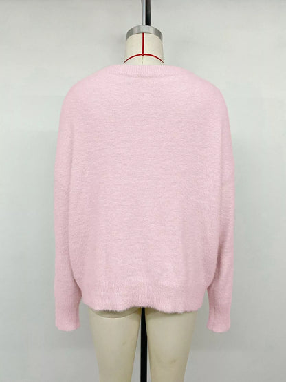 Pink fluffy long sleeve sweater by Trendsi, cozy knit top with a soft, textured fabric and relaxed fit for casual wear.