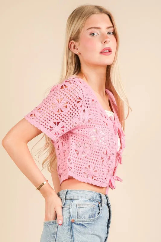 Pink Very J front tie crochet crop top from Trendsi, featuring a stylish design with a front tie and crochet details.