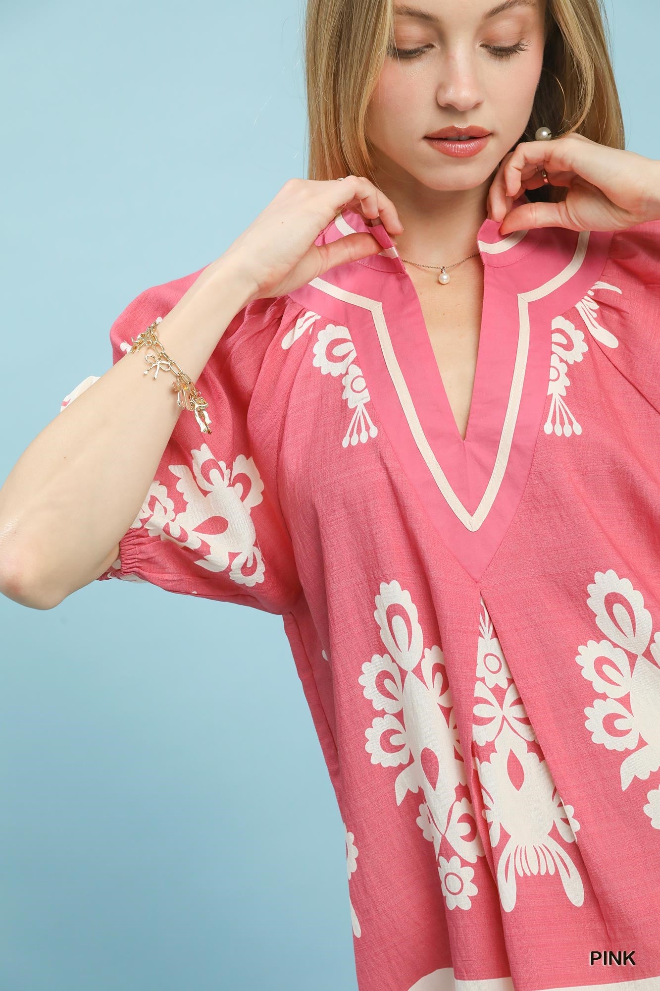 Pink Umgee boho print split-neck short sleeve top with relaxed fit, stylish and comfortable for casual wear.