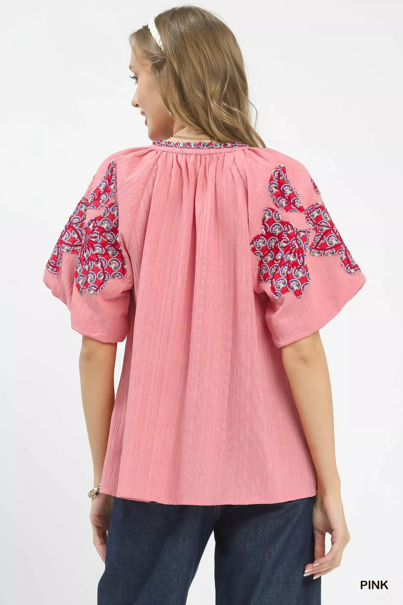 Pink Umgee embroidered sleeve contrast trim top featuring detailed embroidery and stylish design for casual wear.