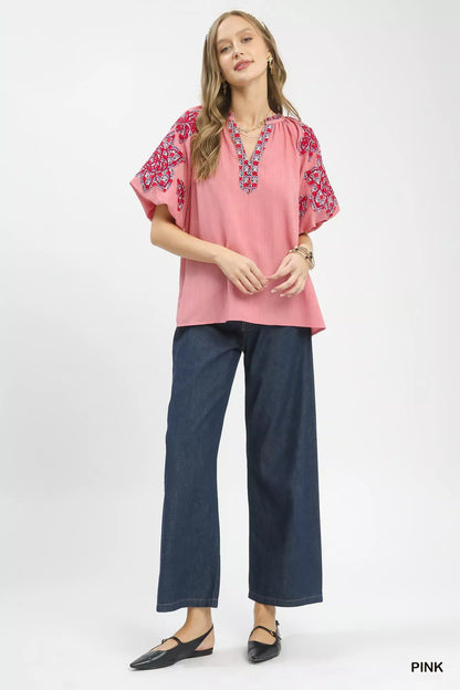 Pink Umgee embroidered sleeve contrast trim top featuring floral embroidery and relaxed fit, ideal for casual wear.