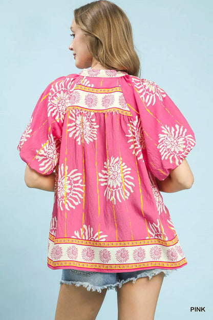 Pink Umgee floral border boho blouse with smocked V-neck and long sleeves, featuring a relaxed, feminine style.