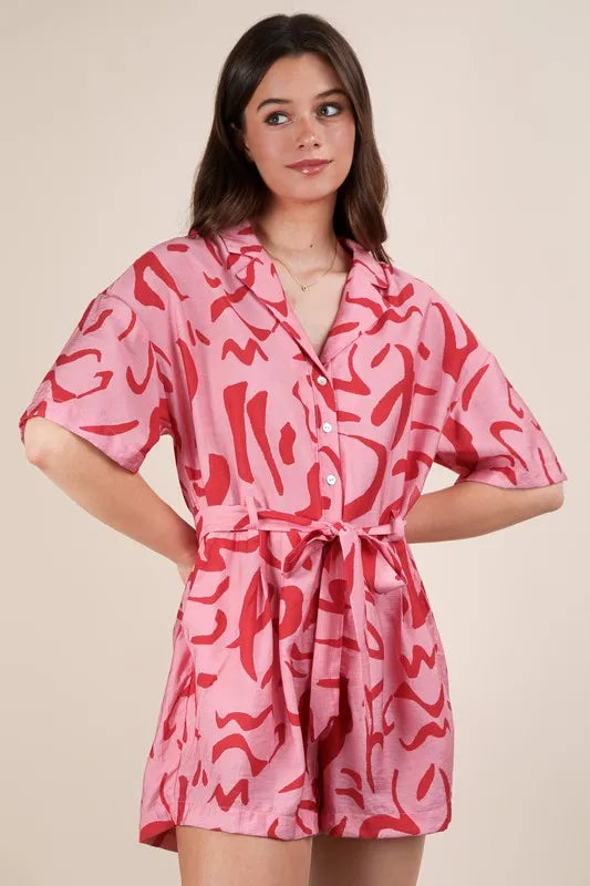 Pink oversized printed button-down resort romper by VERY J, styled with a relaxed fit and vibrant floral pattern.