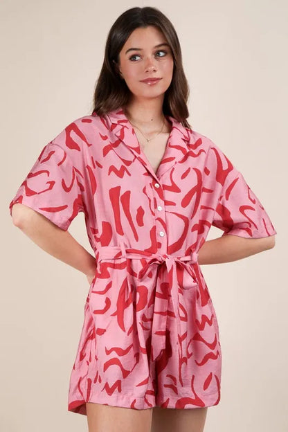 Pink oversized printed button-down resort romper by VERY J, styled with a relaxed fit and vibrant floral pattern.