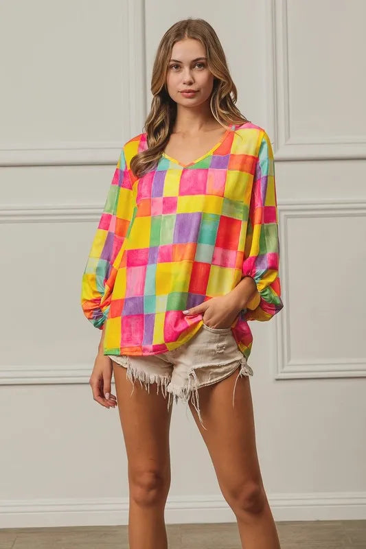 Pink, yellow, and blue BiBi Multi Block Bubble Pop Balloon Top by Trendsi, featuring colorful bubble designs and a stylish cropped fit.