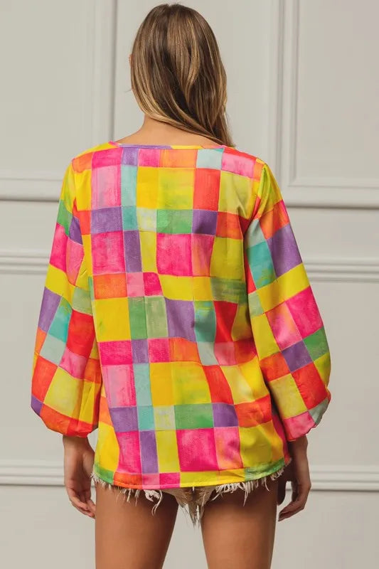 Pink, yellow, and blue BiBi Multi Block Bubble Pop Balloon Top by Trendsi, featuring colorful bubble print and a stylish cropped design.