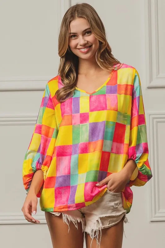 Pink, yellow, and blue BiBi Multi Block Bubble Pop Balloon Top by Trendsi with colorful bubble pattern and casual fit.