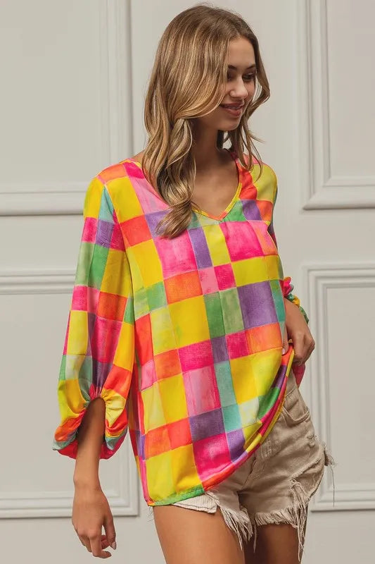 Pink, yellow, and blue BiBi Multi Block Bubble Pop Balloon Top by Trendsi, styled with colorful balloon-inspired design.