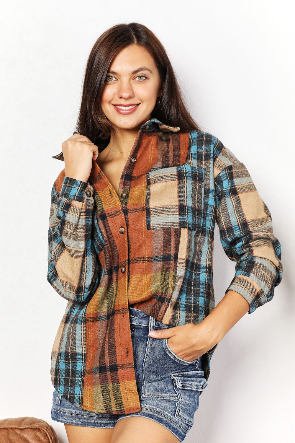 Trendsi Double Take plaid shirt jacket with curved hem and breast pockets, featuring a stylish layered look and casual fit.
