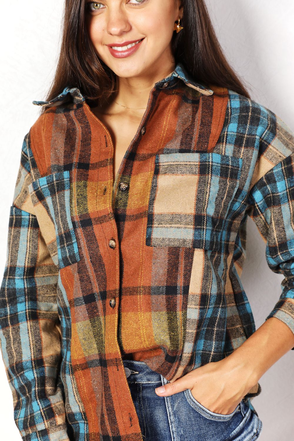 Trendsi Double Take plaid shirt jacket with curved hem, breast pockets, long sleeves, and button front in classic plaid pattern.