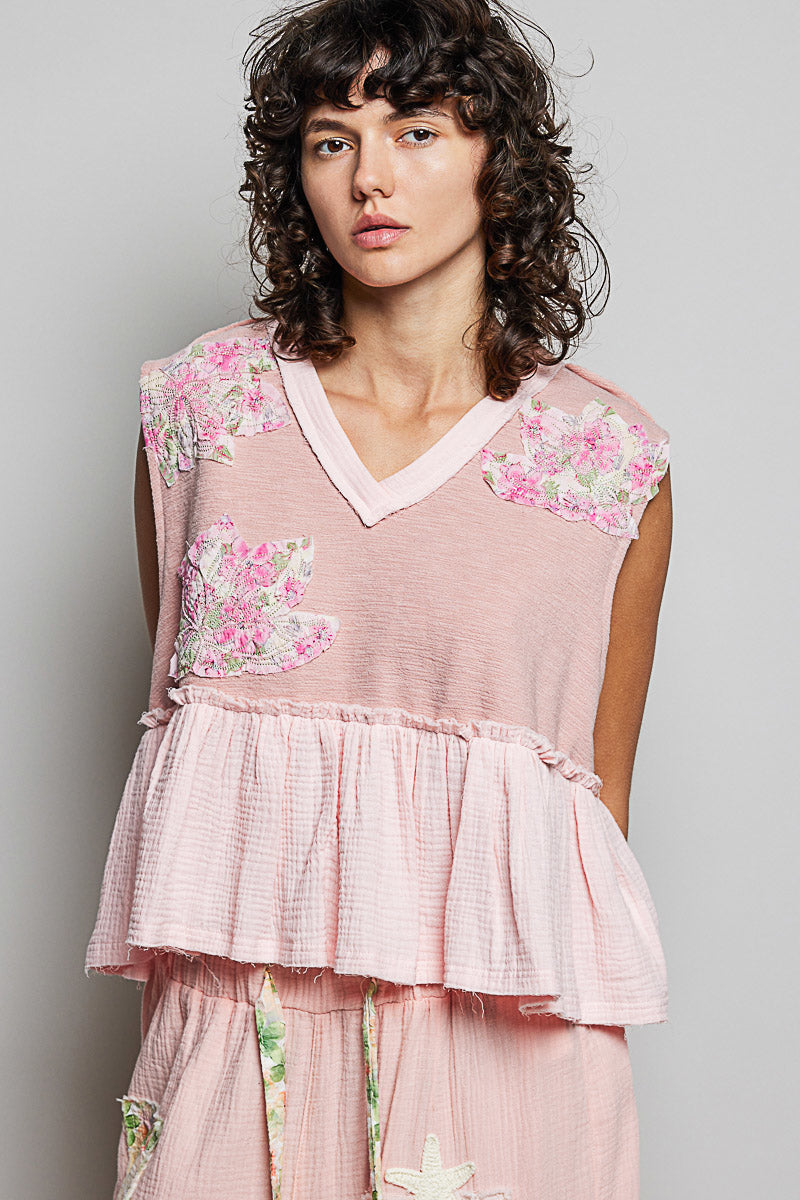 Powder pink floral patch ruffled sleeveless top with raw edge detail from Trendsi, showcasing a feminine and casual style.