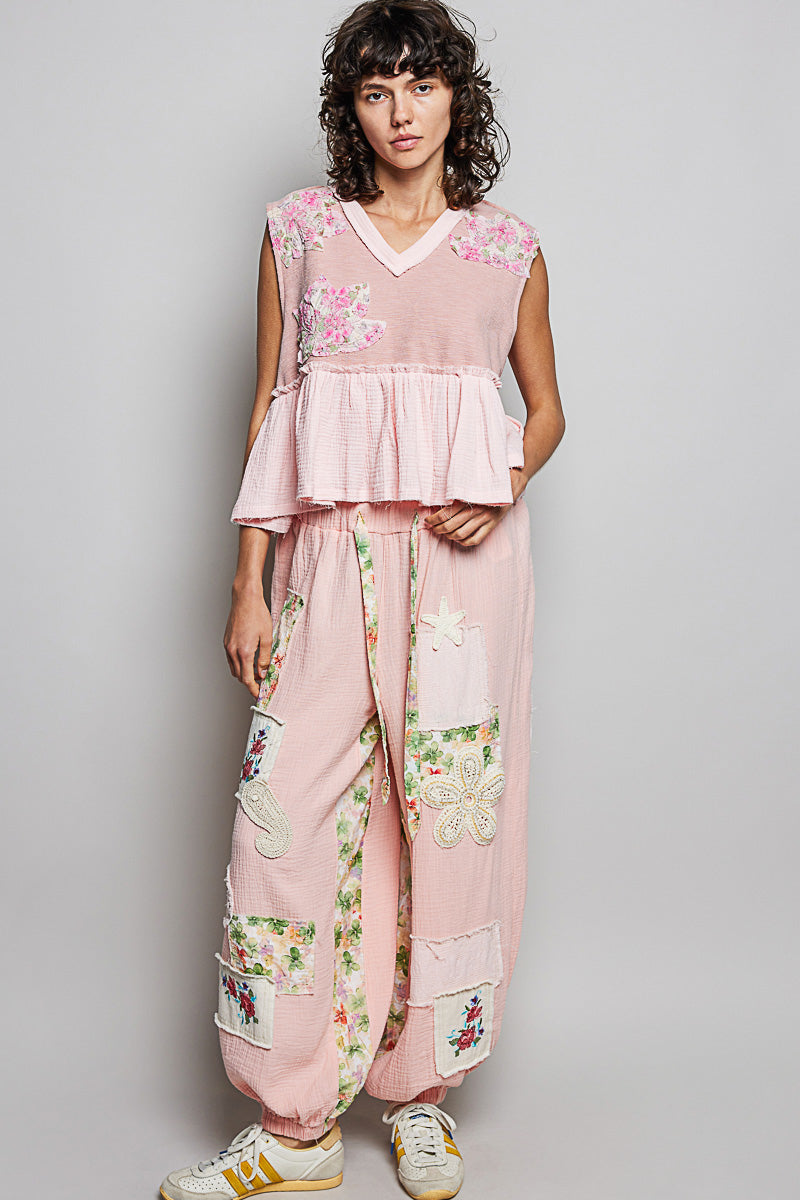Powder pink floral patch ruffled sleeveless top with raw edge detail from Trendsi, showcasing feminine style and textured design.