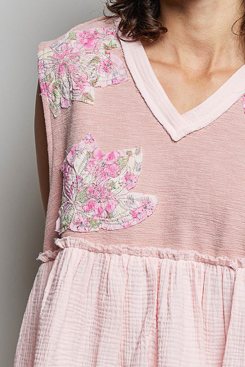 Powder pink floral patch sleeveless top with ruffled details and raw edge accents from Trendsi.