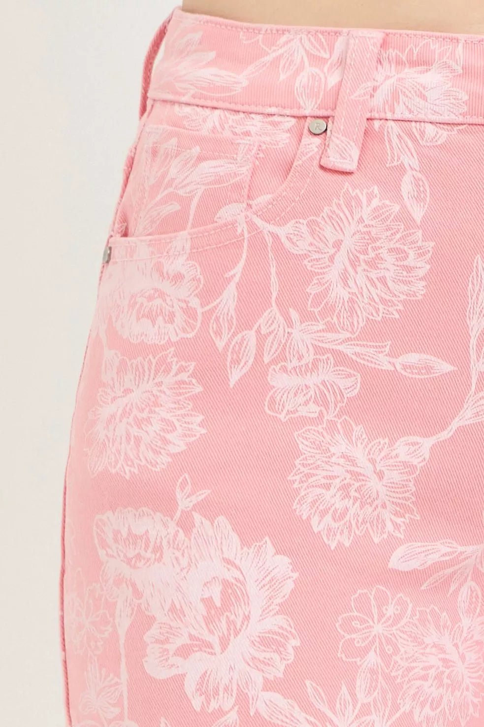 Risen high-rise printed shorts from Trendsi featuring colorful floral pattern and casual fit on a model.