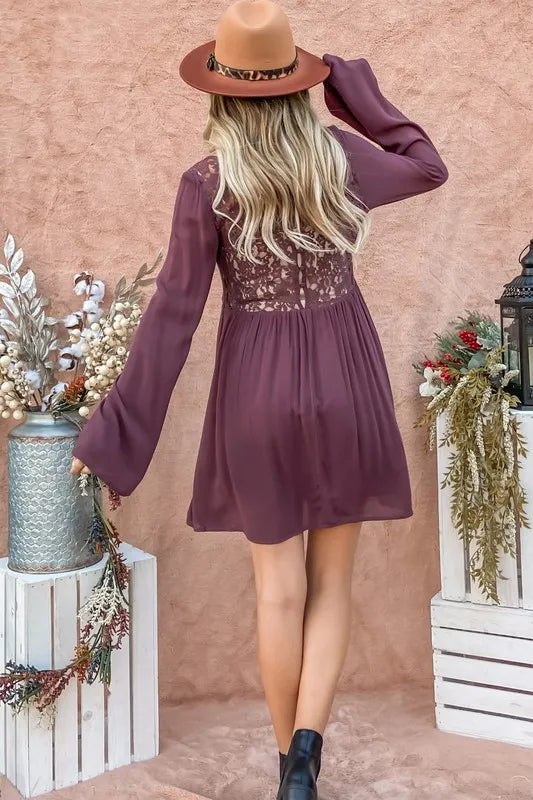 Purple bell sleeve dress by Trendsi featuring back lace detail and button-down front, styled with a fitted silhouette.