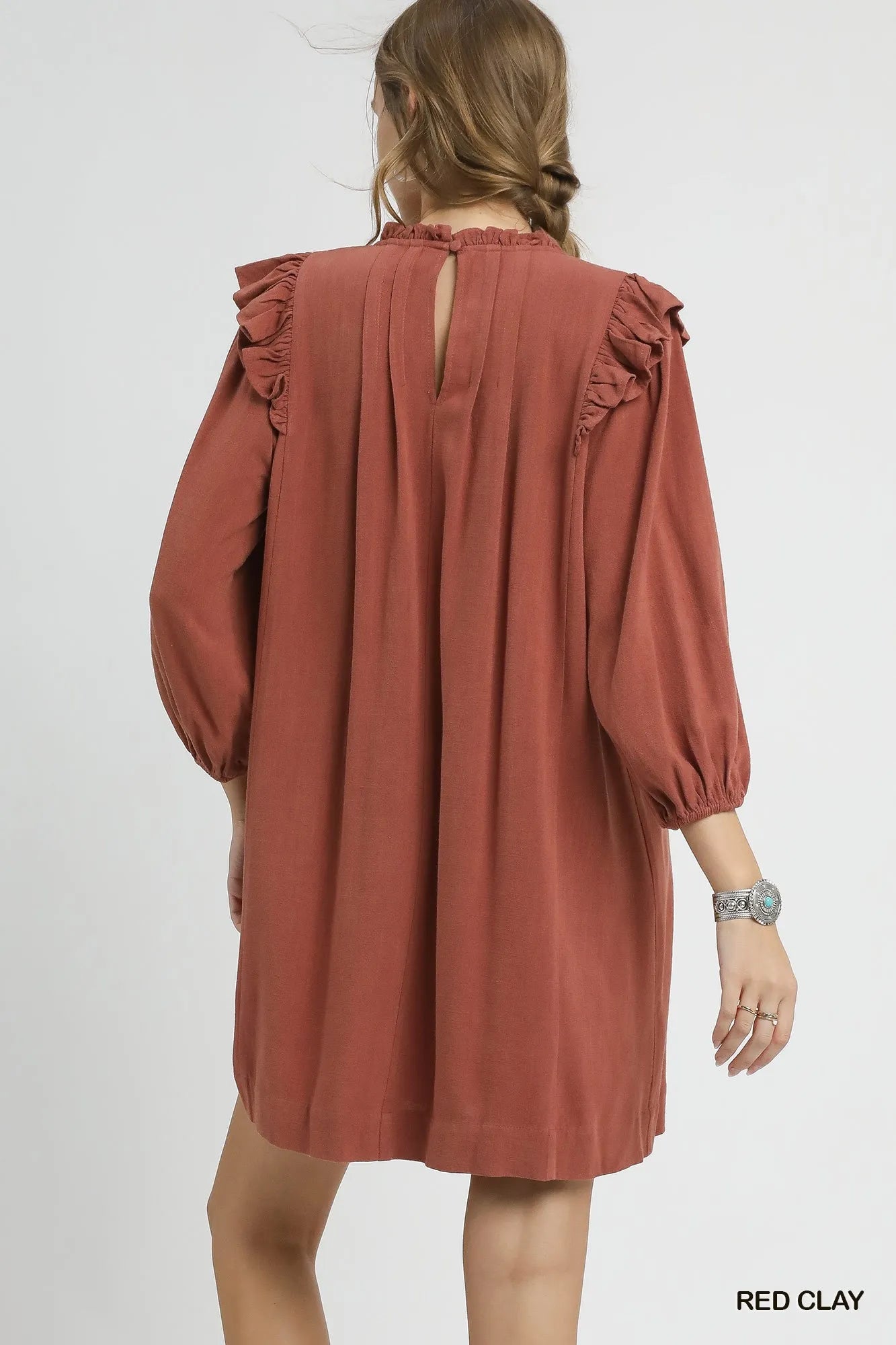 Red clay Umgee linen babydoll dress with ruffle shoulder and pleated design, casual and feminine for everyday wear.