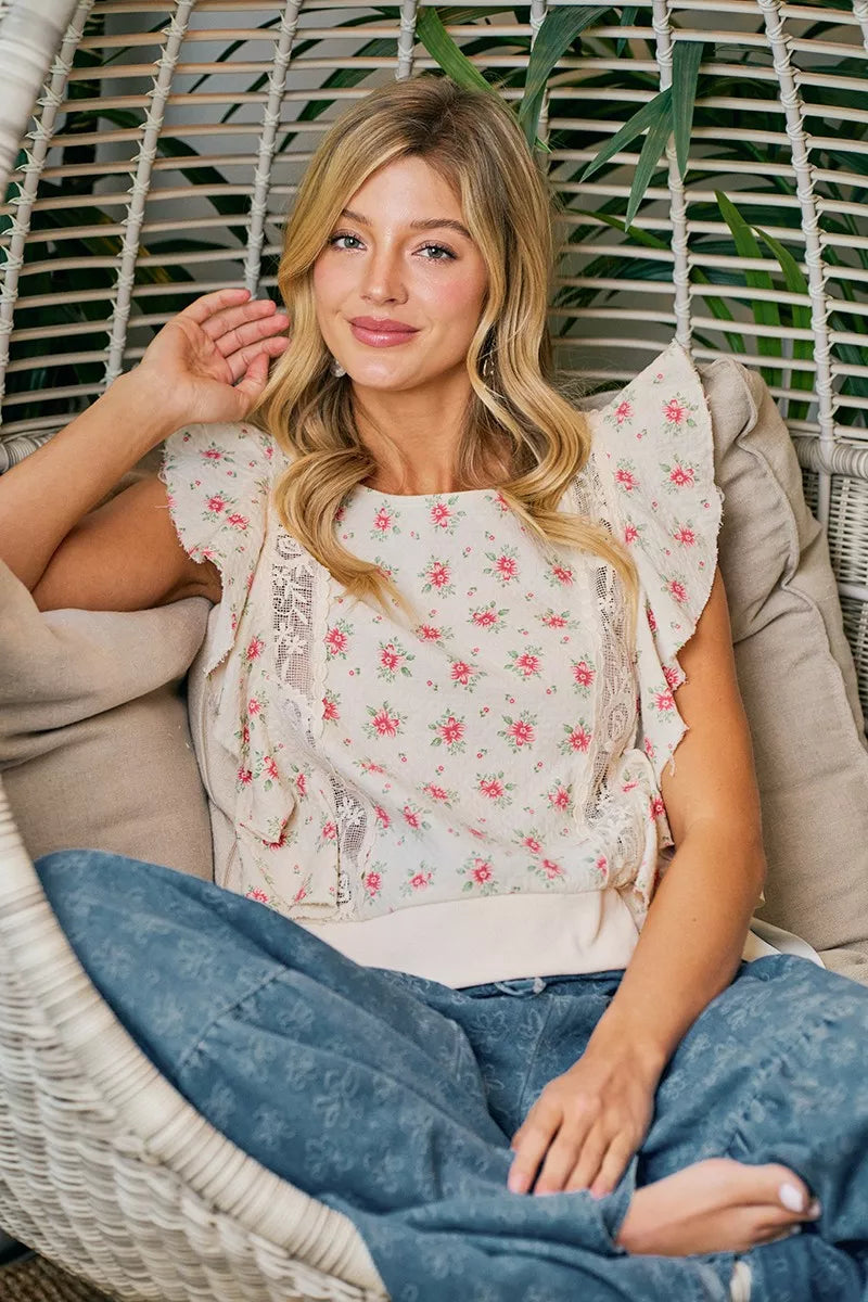 Red floral printed top with ruffle sleeves and trim detail from Trendsi, showcasing a stylish and feminine blouse design.
