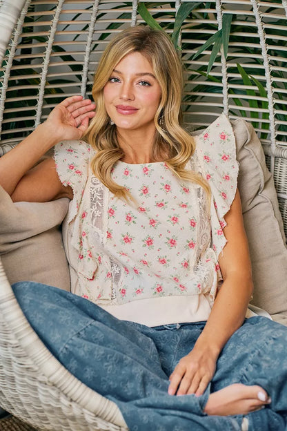 Red floral printed top with ruffle sleeves and trim detail from Trendsi, showcasing a stylish and feminine blouse design.