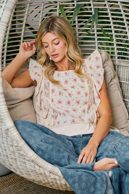 Red floral printed top with ruffle sleeves and trim detail from Trendsi, showcasing a stylish and feminine design.