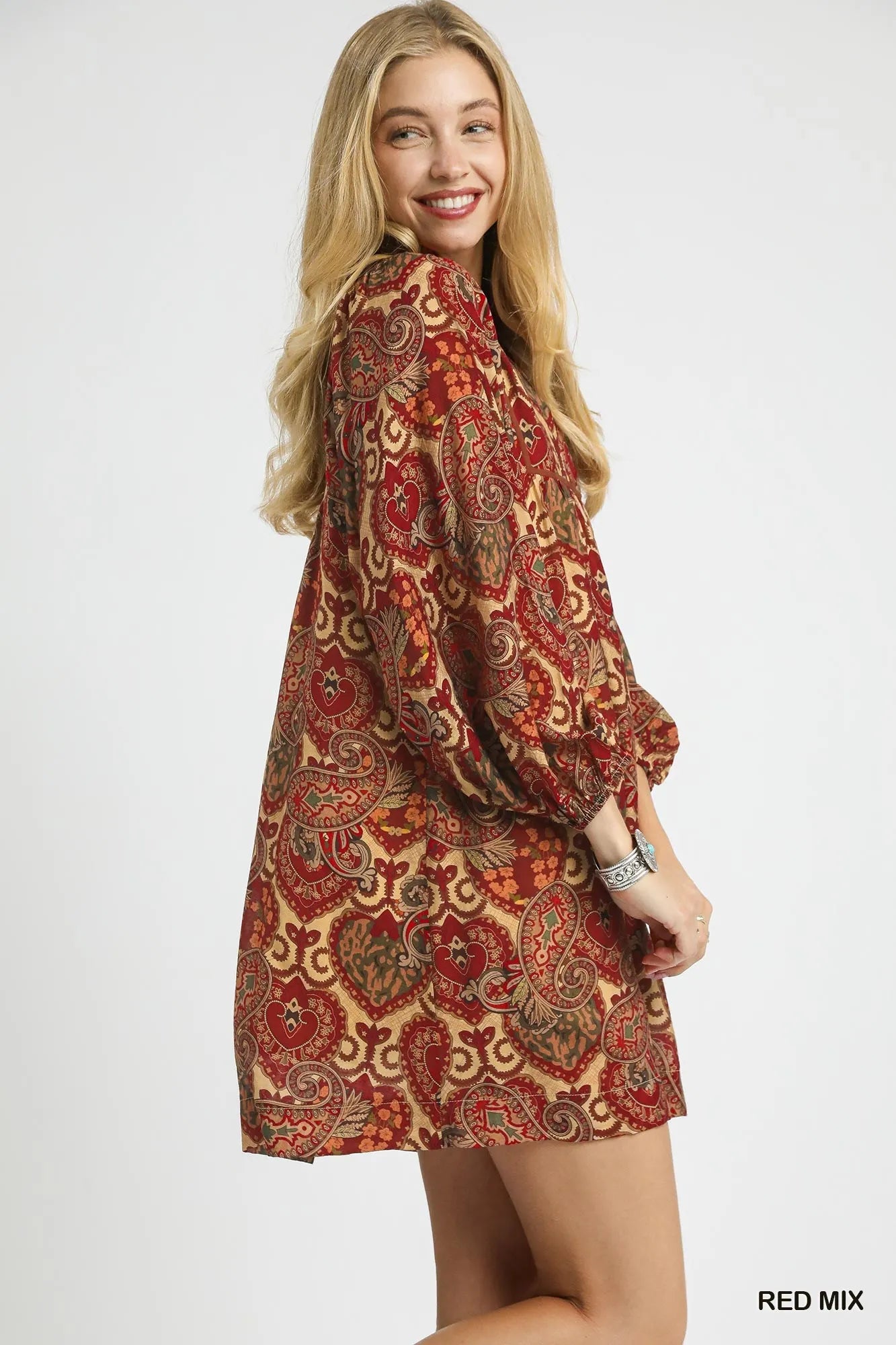 Red boho paisley babydoll dress by Umgee featuring a relaxed fit and flowy silhouette, styled with long sleeves and a V-neck.