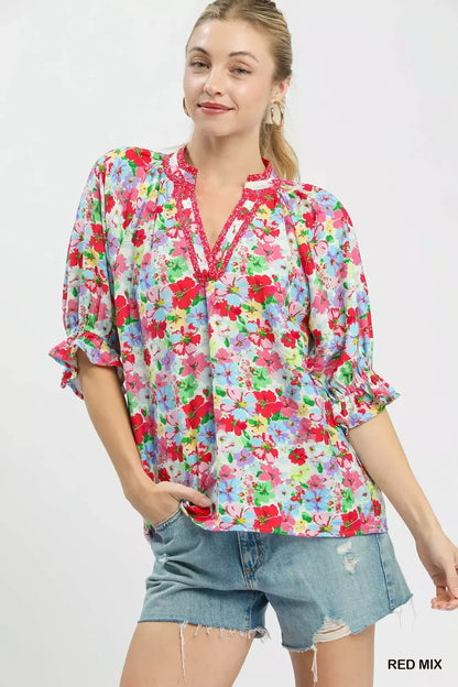 Red floral print ruffle top by Umgee with mixed floral pattern and feminine ruffle details, perfect for casual or dressy occasions.