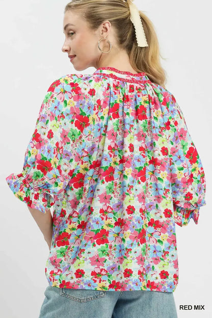 Red Umgee floral print ruffle top with mixed floral pattern, short sleeves, and ruffled details, perfect for casual or dressy wear.