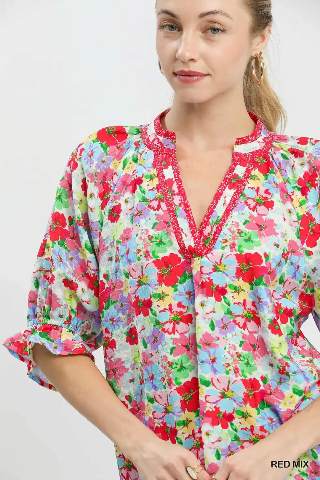 Red Umgee floral print ruffle top with mixed floral pattern and ruffled sleeves, perfect for casual or dressy occasions.