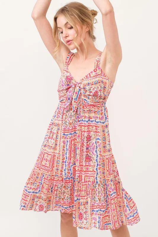 Red multi-tiered boho printed dress with tied front and smocked back, by Trendsi, featuring a relaxed, tiered silhouette.