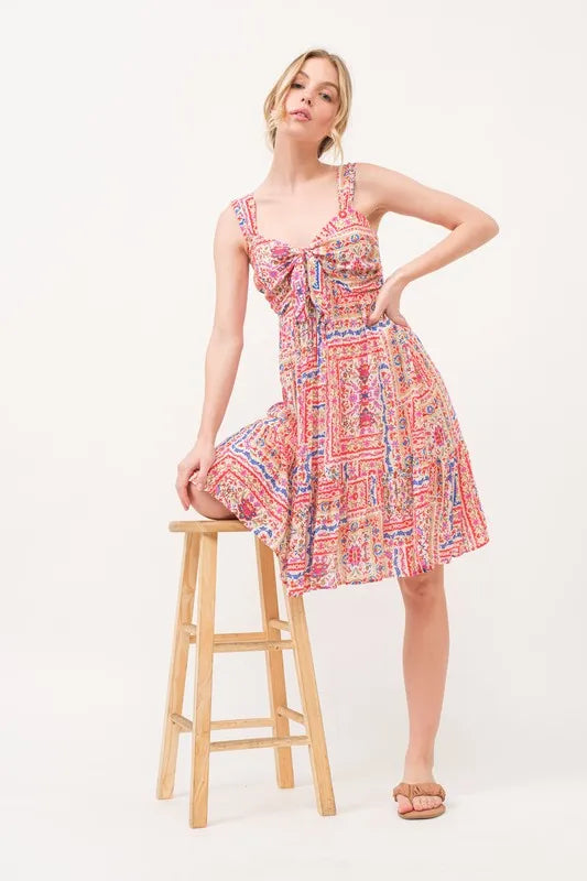 Red multi-colored boho printed dress with tied front, smocked back, and tiered design by Trendsi, perfect for casual summer wear.