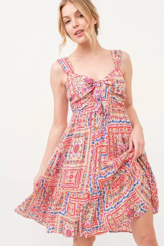 Red multi-colored boho printed dress with tied front, smocked back, and tiered design by Trendsi, perfect for casual summer wear.