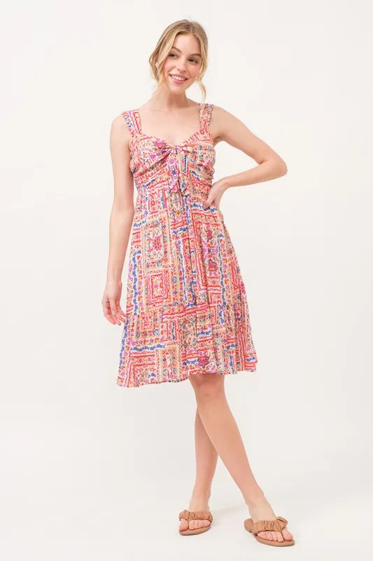 Red multi-colored boho printed dress with tie-front and smocked back, featuring a tiered design by Trendsi.