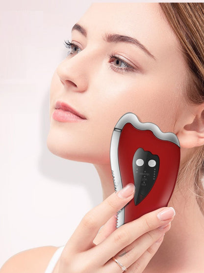 Red Trendsi vibration facial beauty device with ergonomic design for skin rejuvenation and facial massage.