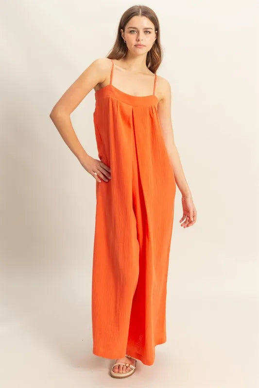 Red-orange HYFVE double gauze cami jumpsuit with a flowy silhouette, featuring thin straps and a relaxed fit.