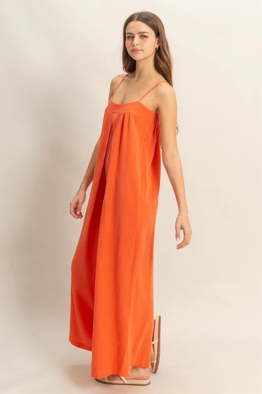 Red-orange HYFVE double gauze cami jumpsuit with a super flowy fit, featuring a sleeveless design and relaxed silhouette.