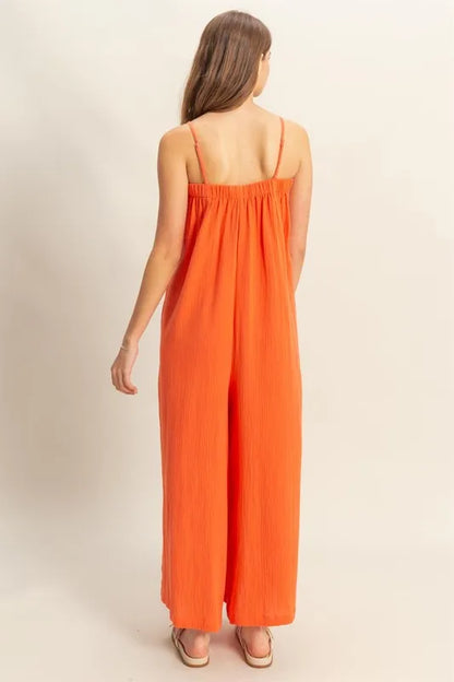 Red-orange HYFVE double gauze cami jumpsuit with a super flowy, relaxed fit, featuring thin straps and a stylish, comfortable design.