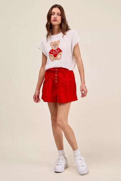 Red SO ME solid twill denim pintucked buttoned shorts with waist tie, styled with front pockets and casual fit.