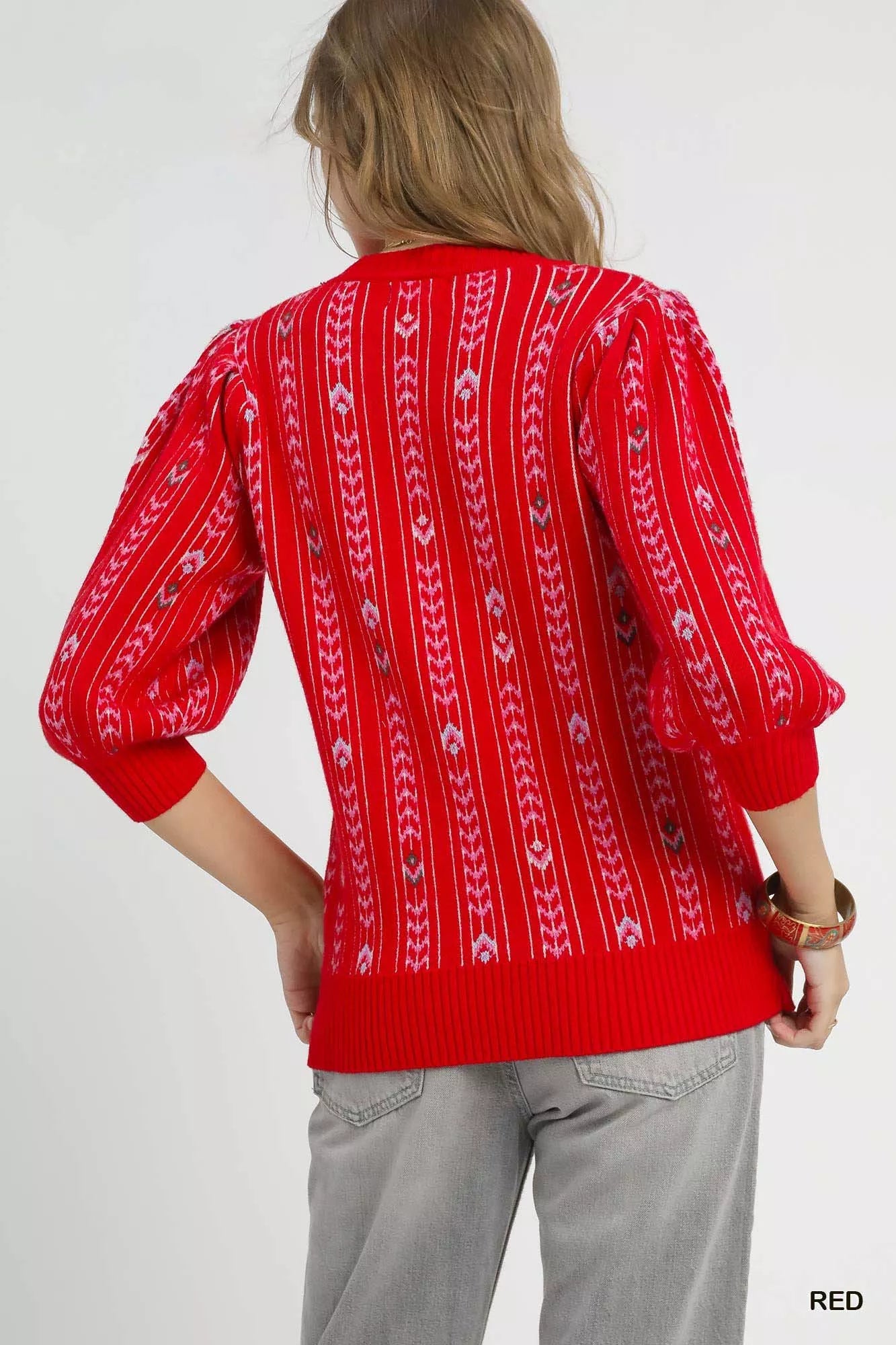 Red Umgee jacquard knit puff sleeve sweater featuring a cozy, stylish design with intricate patterns and ribbed cuffs.