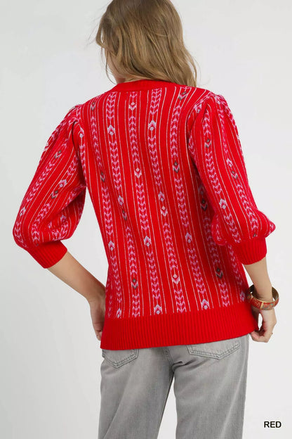 Red Umgee jacquard knit puff sleeve sweater featuring a cozy, stylish design with intricate patterns and ribbed cuffs.