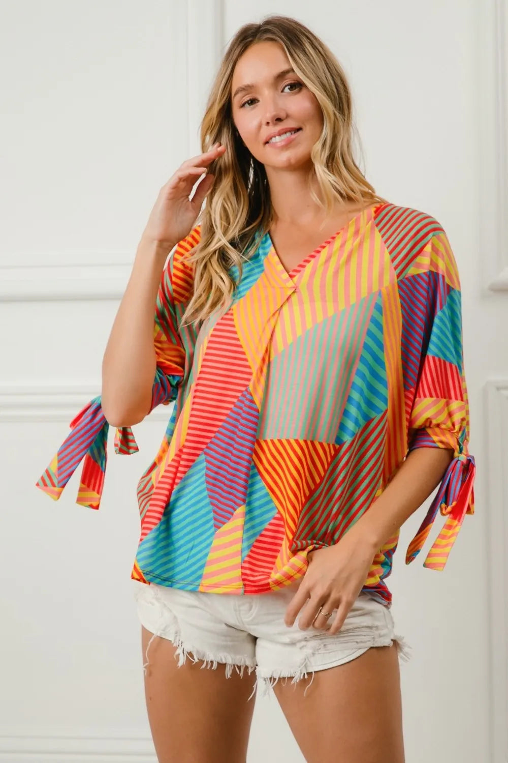 Trendsi BiBi multi-stripe block printed jersey blouse with tied sleeves, featuring vibrant red, yellow, and green colors.