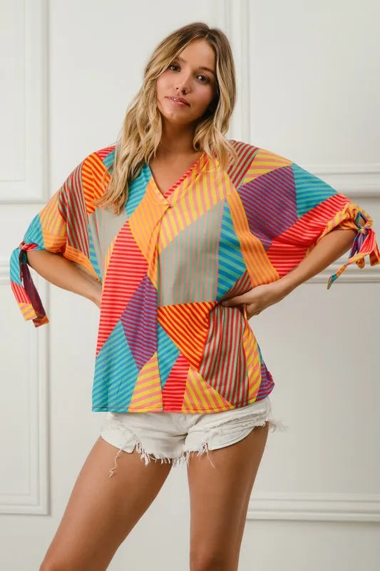 Trendsi BiBi multi-stripe block printed jersey blouse with tied sleeves, featuring vibrant red, yellow, and green colors.