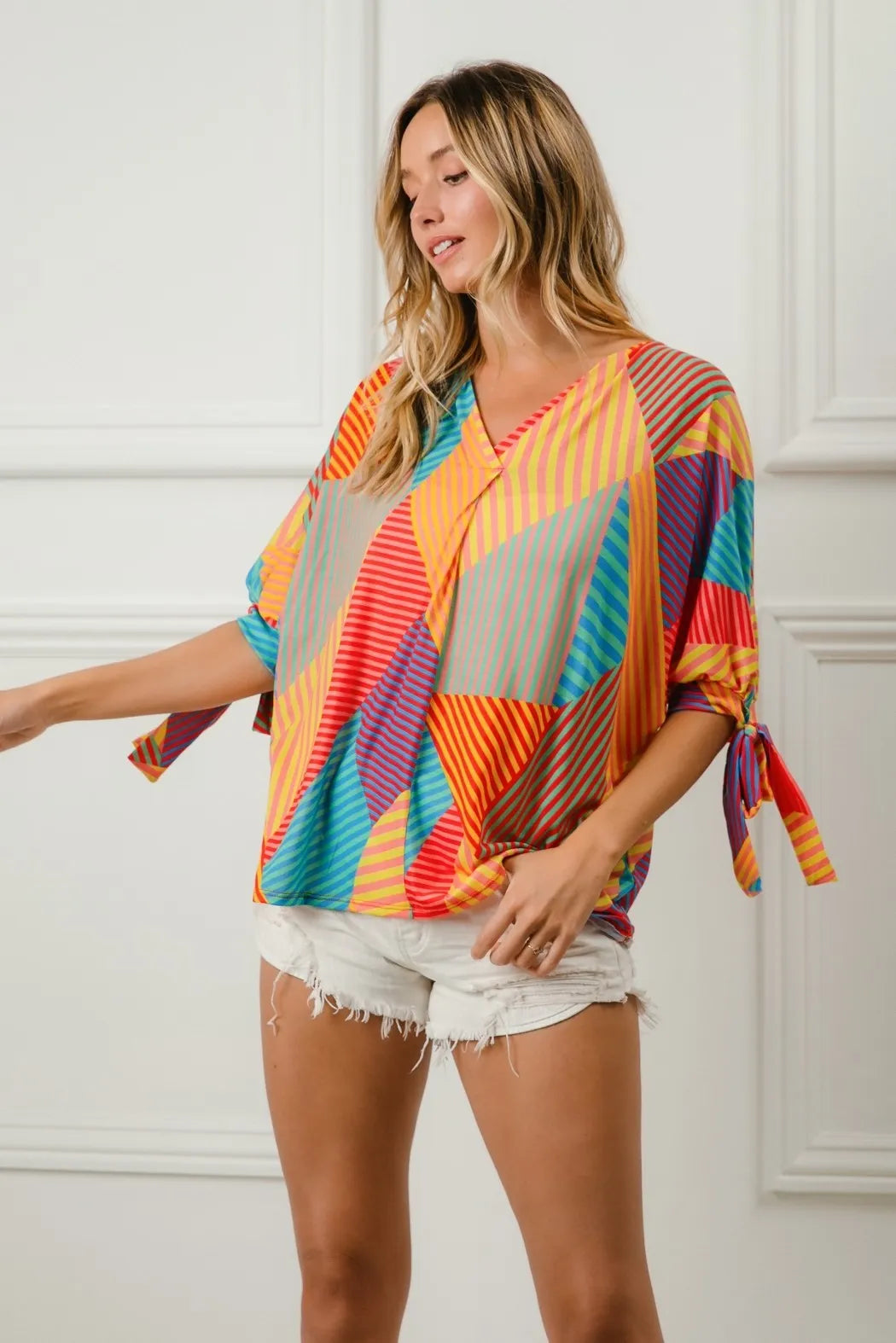 Trendsi BiBi multi-stripe block printed jersey blouse with tied sleeves in red, yellow, and green colors.