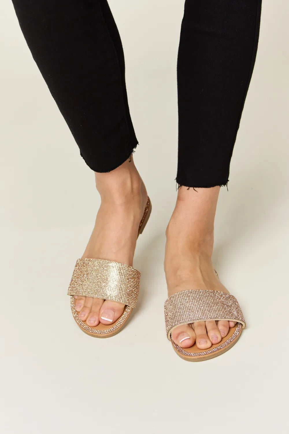 Rose gold Wild Diva rhinestone open toe flat sandals with stylish straps, perfect for casual or dressy summer wear.