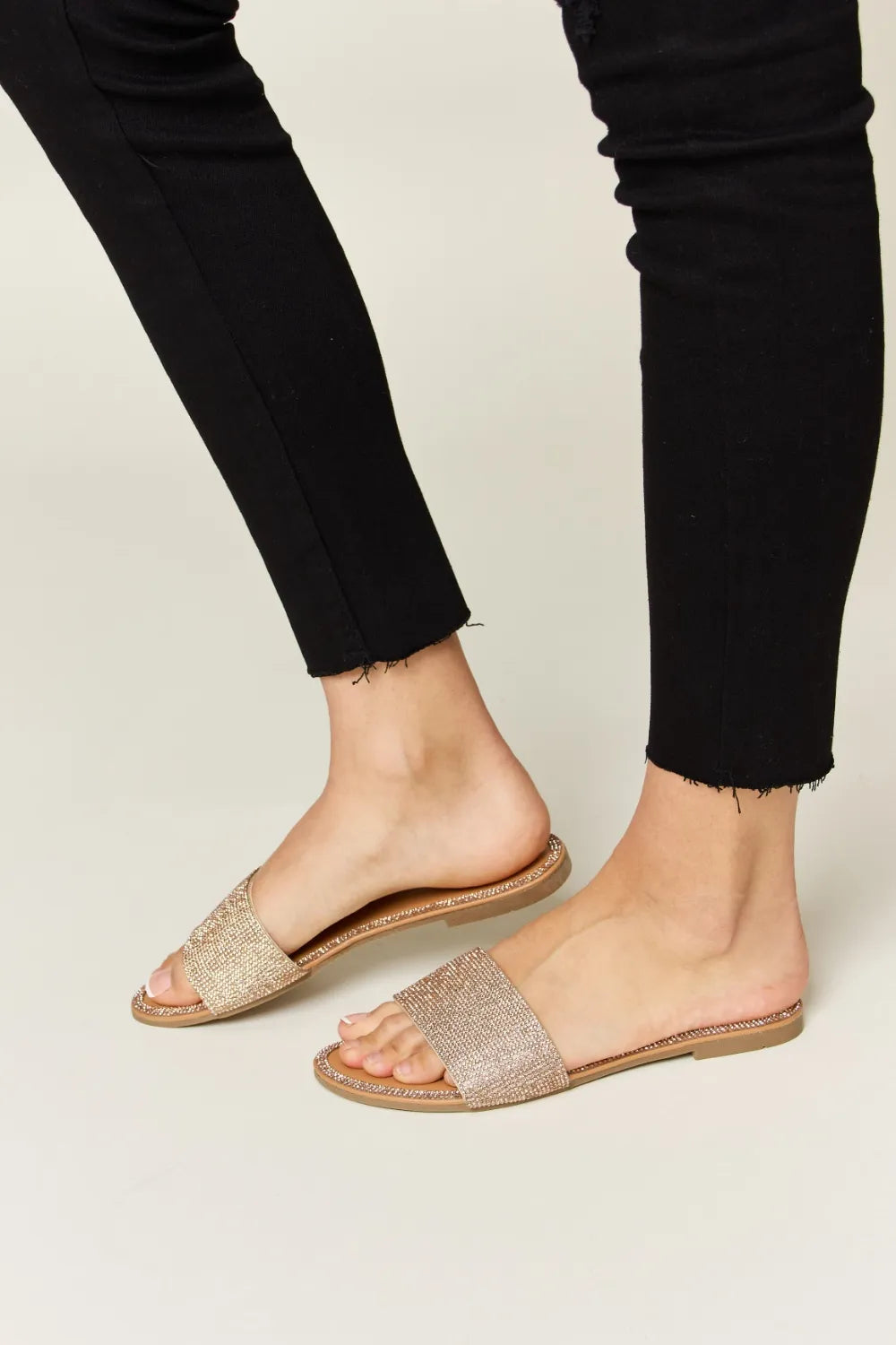 Rose gold Wild Diva rhinestone open toe flat sandals with strappy design and sparkling embellishments, perfect for casual or dressy wear.