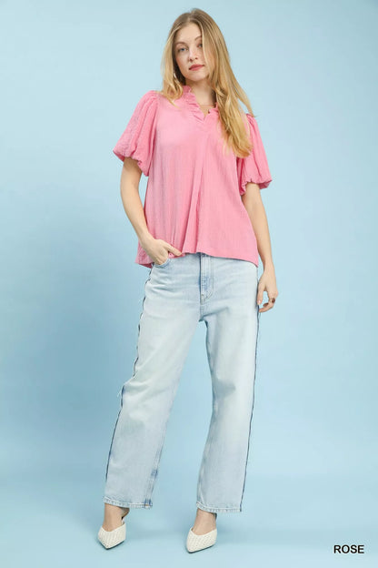 Pink Umgee Seersucker Puff Sleeve Blouse with ruffled collar and puffed sleeves, displayed on a hanger.