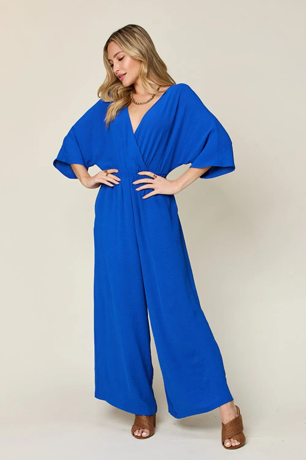 Royal blue Trendsi Double Take full-size surplice wide-leg jumpsuit with pockets, featuring a stylish, comfortable design.