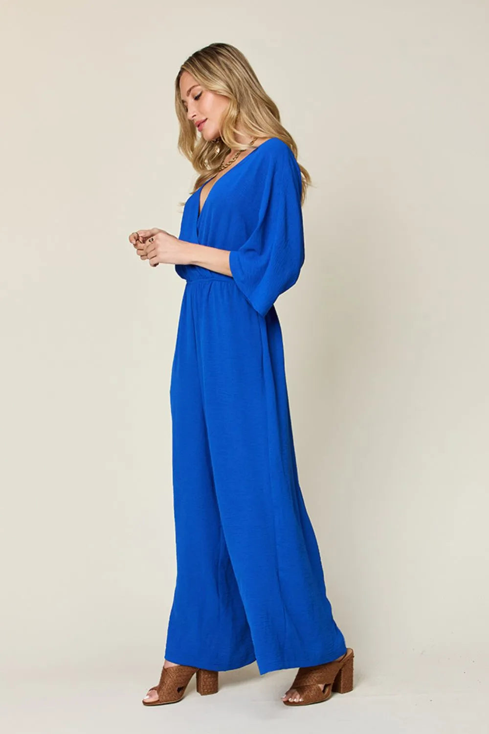 Royal blue Trendsi double take full-size surplice wide-leg jumpsuit with pockets, featuring a stylish and comfortable design.