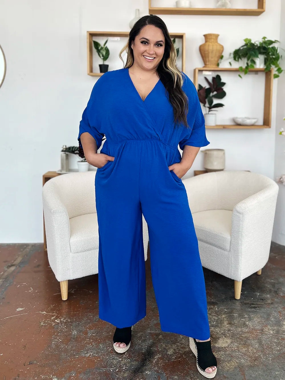 Royal blue Trendsi Double Take surplice wide-leg jumpsuit with pockets, full size, featuring a stylish wrap design and flowing legs.