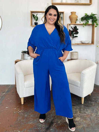 Royal blue Trendsi Double Take surplice wide-leg jumpsuit with pockets, full size, featuring a stylish wrap design and flowing legs.