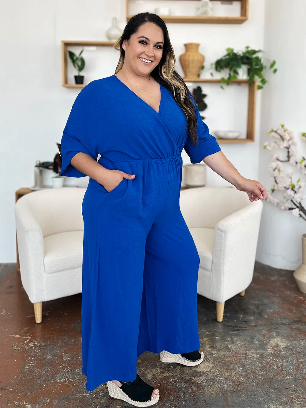 Royal blue Trendsi Double Take full-size surplice wide-leg jumpsuit with pockets, featuring a stylish surplice neckline and flowing wide legs.